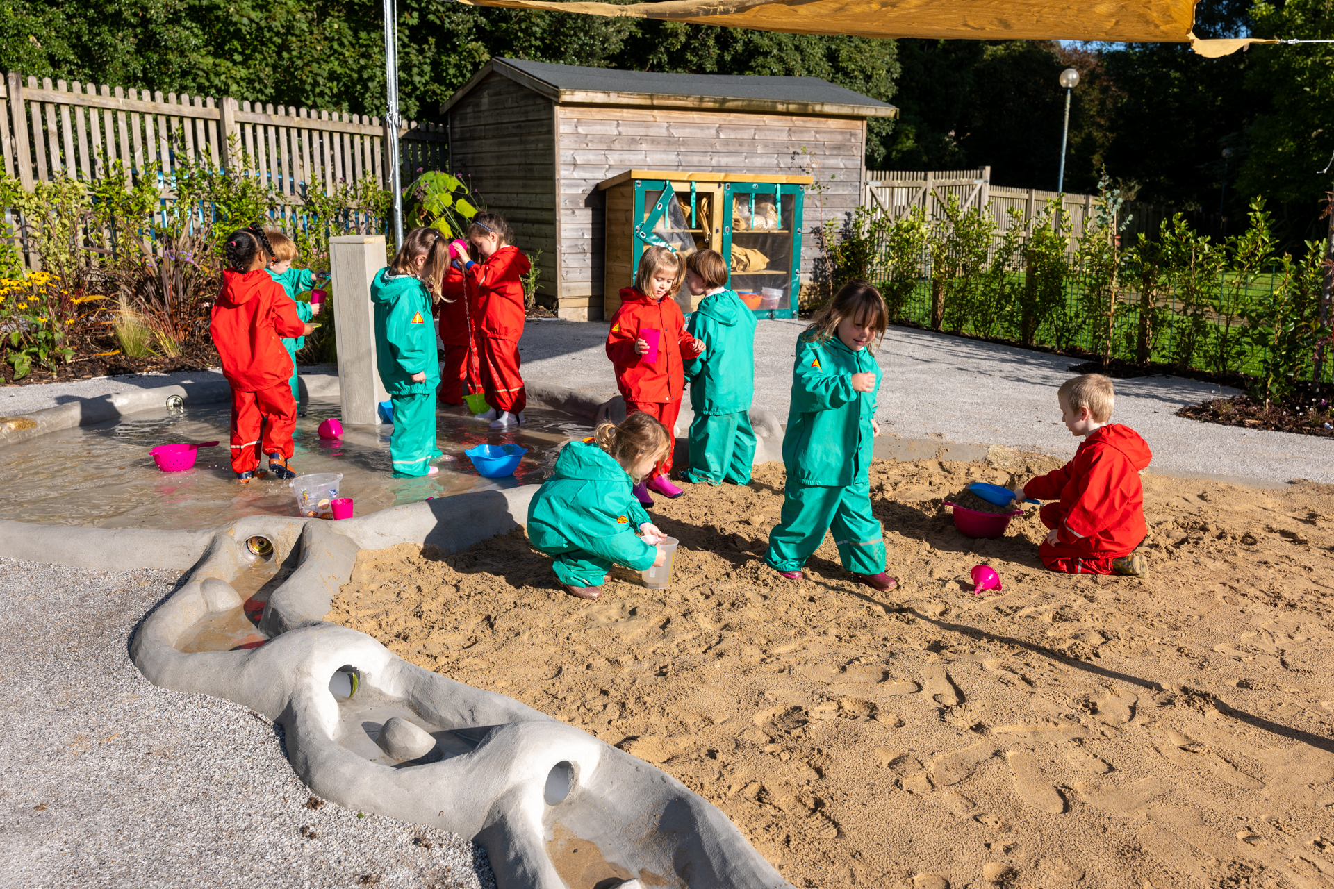 Children playing in sand and water garden at Pondhu Primary School